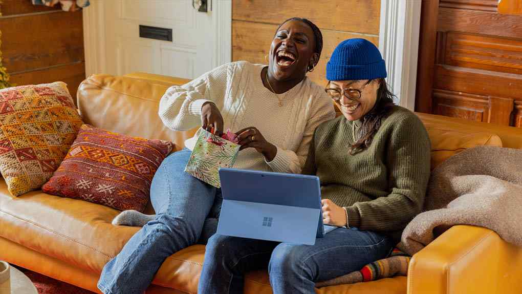 Young South Africans learning together on a laptop